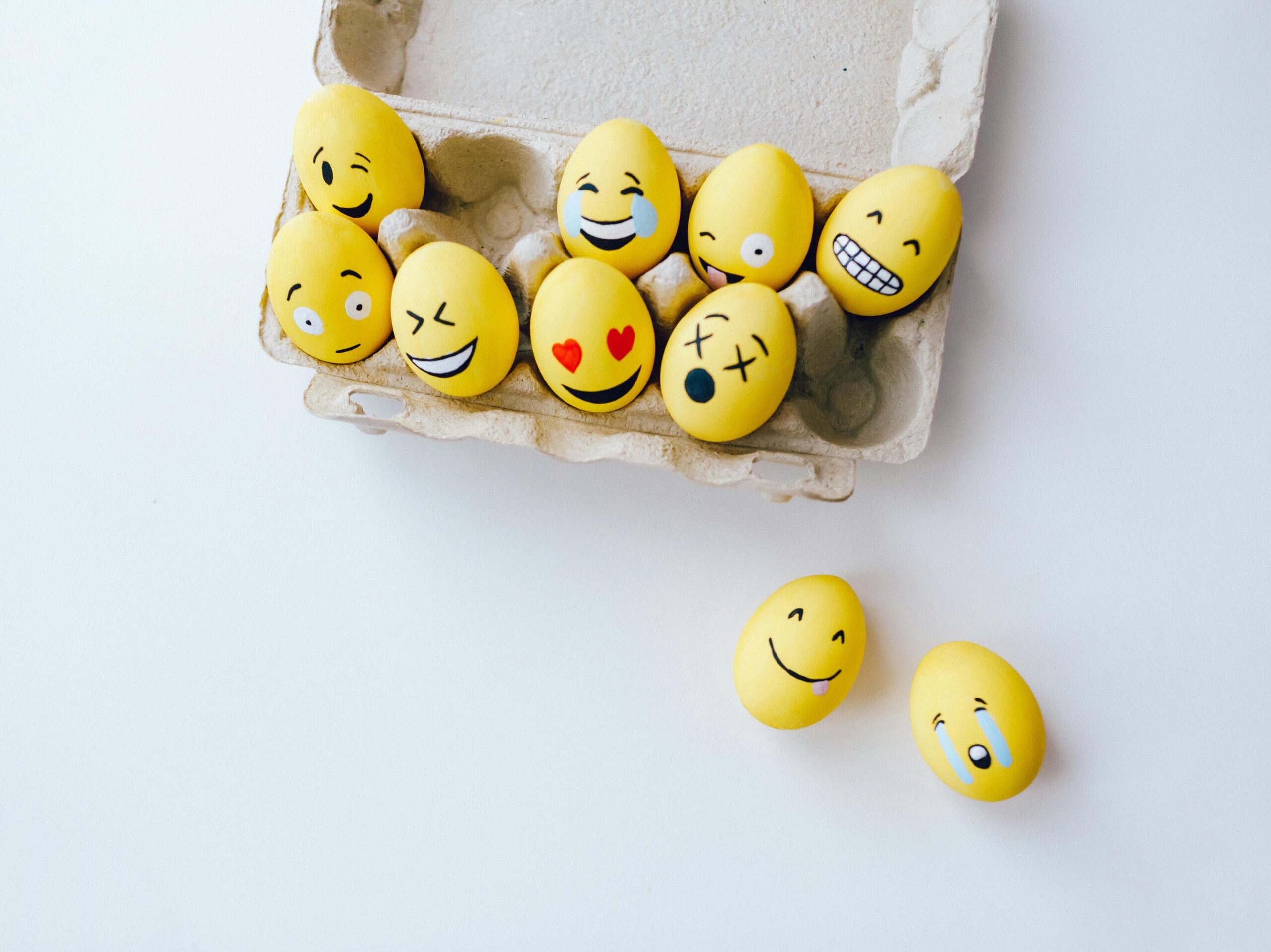 pexels-photo-6898859-6898859 Colorful yellow Easter eggs decorated with emoji faces in a carton, adding a fun and creative touch to the holiday.